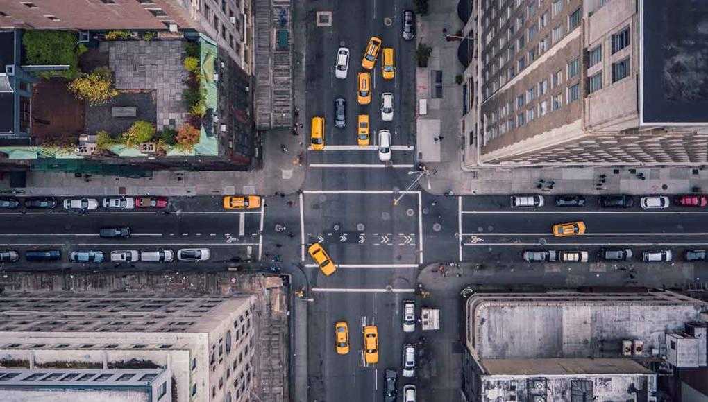 What NYC’s Plan for Improving Pedestrian Safety Means for You - A bustling city with numerous cars on the streets.