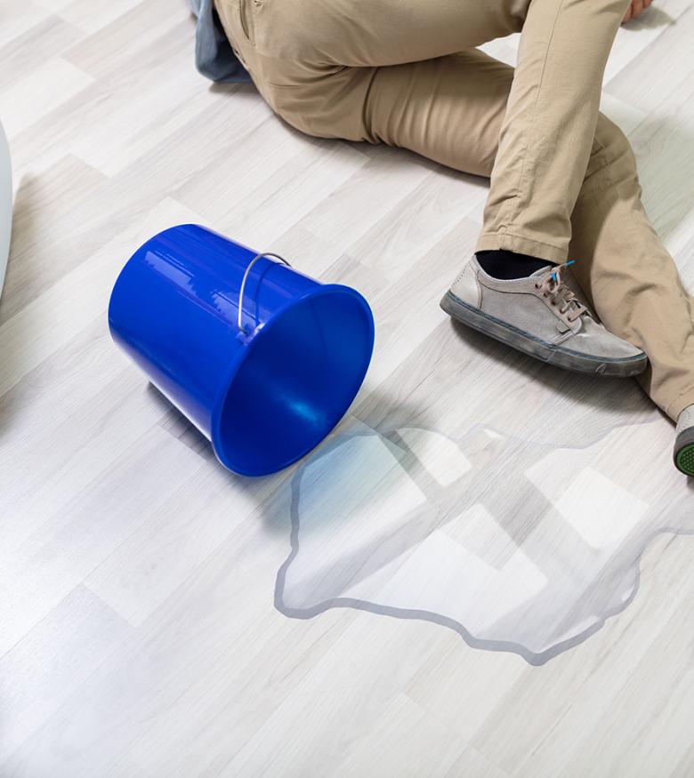 Slip & Fall Lawyers in Detroit, Michigan (MI) - Man on floor with spilled bucket of water
