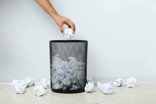 throwing paper in the trash
