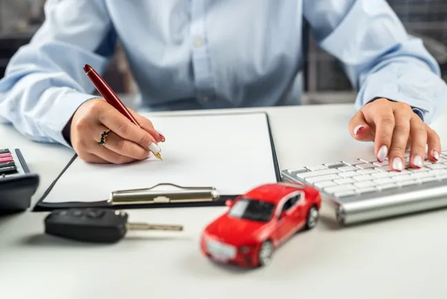 On the Road with Confidence: A Deep Dive into Rental Car Insurance - signing insurance forms