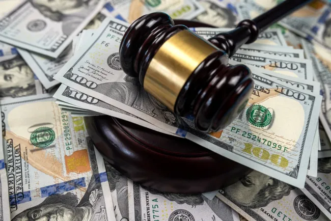 What Damages Can You Sue For - judge hammer with cash