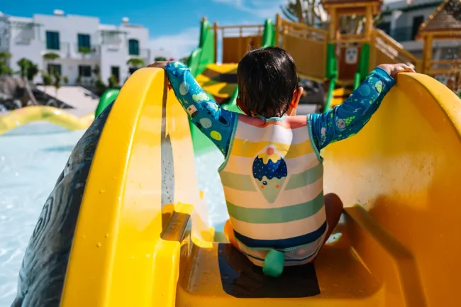 What Should I Do After a Water Park Injury in California - kid going down the water slide