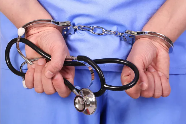 Florida Whistleblower Exposes Healthcare Fraud - Doctor with a handcuff