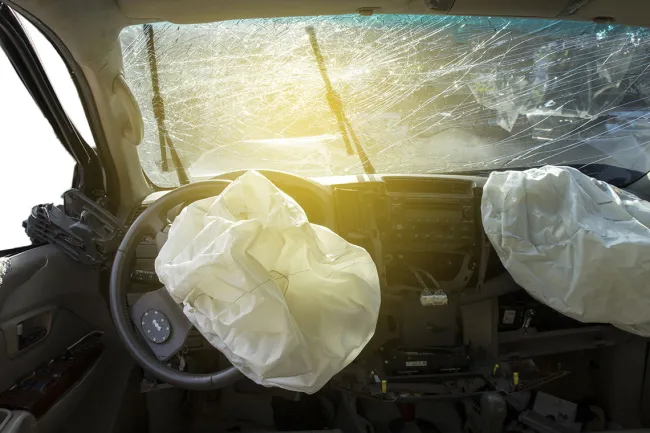 Takata Recall Expands as Death Toll Rises - An deployed airbag in a vehicle post-collision