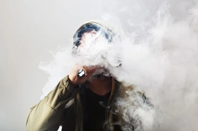 Philly’s Helpful Vape Laws Could Spread to More of PA - A man exhaling a cloud of vapor from his vape