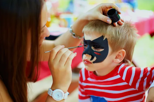 Is Your Child’s Halloween Makeup Tainted with Lead? - An artist applying face painting on a child's face