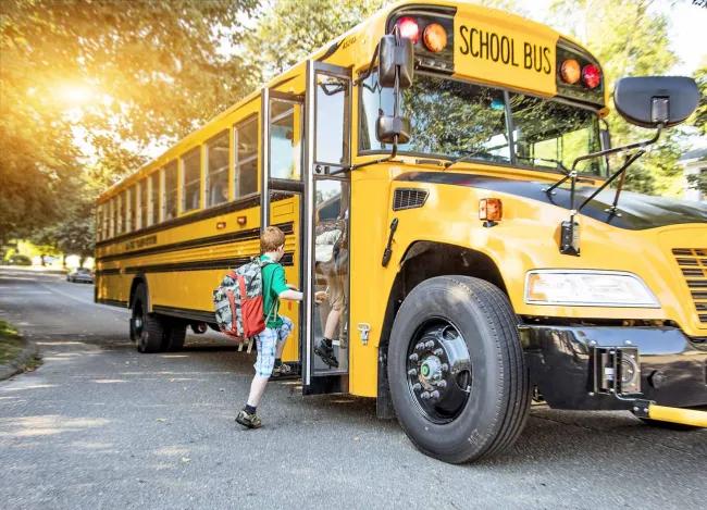 Kids getting on school bus